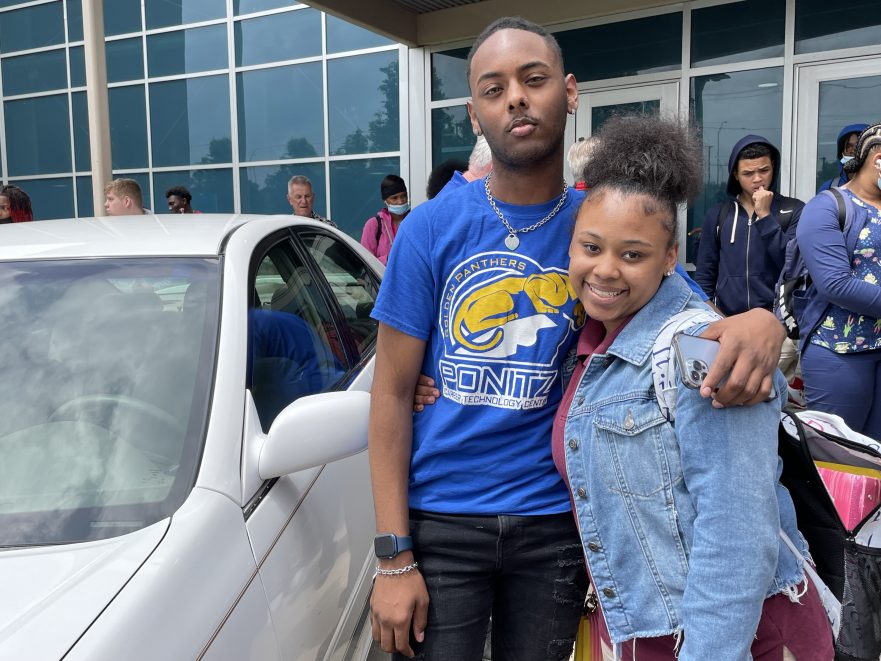 Thomas Terrell poses with sister Jamese Easterling in front of the Toyota Camry.